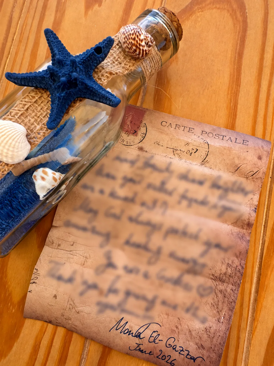 Shell-decorated retreat keepsake and handwritten note, with the personal message blurred and Mona El-Gazzar’s signature visible